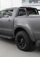 Sleek gray Ford truck with rugged black wheels, showcasing a dynamic and modern design ideal for adventure and performance.