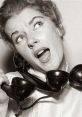 Woman expressing frustration while holding a vintage telephone, embodying the concept of an "Angry Old Lady" moment.