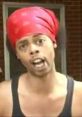 Antoine Dodson passionately delivering a message wearing a red bandana, known for the Bed Intruder viral meme.