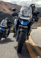 Two motorcyclists on a winding road, showcasing adventure touring bikes with a focus on performance and stability in action.