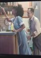 Controversial Gillette advert scene featuring a woman in a blue dress and a man reaching towards her in a kitchen setting.