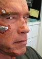 Arnold Schwarzenegger close-up with dramatic makeup effects, featuring scars and metal pieces, inspired by prank call themes.