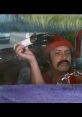 Cheech holding a joint in a colorful car, embodying the stoner humor of Cheech and Chong's classic films.