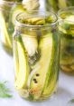 Freshly pickled cucumbers in a jar with spices, dill, and brine, showcasing a vibrant and flavorful preserve option.