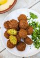 Falafel The sizzle of hot oil as it envelops the chickpea mixture, creating the crispy outer layer of a basic falafel.