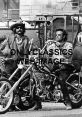 Dennis Hopper, iconic actor and filmmaker, rides a custom motorcycle in a vintage black-and-white photo.