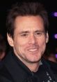 Jim Carrey smiles at a premiere event, showcasing his signature humor and charisma in a stylish black coat.