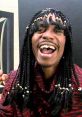 Dave Chappelle as Rick James, laughing and showcasing his iconic style from the "Prank Call" sketch. Legendary comedy moment.