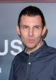 Tim Westwood poses confidently at a red carpet event, showcasing his distinct style and charismatic presence.