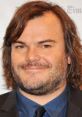 Jack Black smiling at an event, showcasing his signature style and charisma, related to his work in "Jumanji 3.