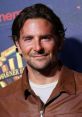 Bradley Cooper smiles confidently, wearing a brown leather jacket, at a movie event promoting his latest film.