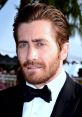 Jake Gyllenhaal in a classic tuxedo, showcasing charm and charisma, tied to his role as Jake The Muss.