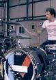 Drummer energetically performing with a unique bass drum design, capturing the lively essence of "Mad World" music.