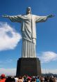 Christ the Redeemer statue towers over crowds, symbolizing faith and peace against a clear blue sky.