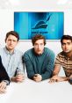 Four tech entrepreneurs seated around a table, with the Pied Piper logo displayed on a screen in a Silicon Valley office setting.