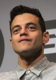 Rami Malek presenting as Elliot Alderson, showcasing a thoughtful expression at a panel event.