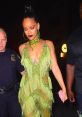 Rihanna steps out in a stunning green fringe dress, showcasing her bold style and confidence amid a night out.