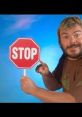 Jack Black playfully holds a stop sign, embodying the phrase "You Better Stop" with a humorous expression and colorful backdrop.