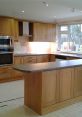 Modern wooden kitchen design featuring a spacious island and stainless steel appliances, perfect for cooking and entertaining.