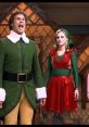 Will Ferrell as Buddy the Elf sings joyfully next to Jovie in a festive scene from the movie "Elf.