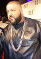 DJ Khaled attends an event wearing a stylish leather outfit and a large gold chain, showcasing his iconic fashion sense.