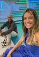 Hosts smiling together on the set of Esporte Espetacular, showcasing vibrant studio colors and a lively atmosphere.