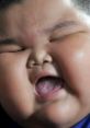 Joyful child expressing happiness, often featured in viral meme songs, capturing a moment of pure delight.