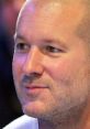 Jony Ive engaged in conversation, showcasing his visionary design approach and influence in technology and innovation.