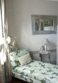 Cozy bedroom corner featuring a floral lounge chair, elegant mirror, and soft decor, perfect for a relaxing retreat.