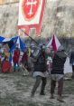 Medieval sword fight between armored knights, showcasing combat skills in a historical reenactment on a grassy field.