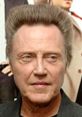 Christopher Walken with distinctive hairstyle at event, known for his comedic roles and memorable prank call performances.