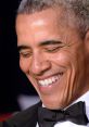 Barack Obama smiling in formal attire, showcasing his trademark joyful expression and charisma at a public event.