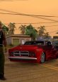 Character in baggy pants next to a red custom car in a Grand Theft Auto 2 urban setting with palm trees at sunset.