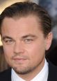 Close-up of Leonardo DiCaprio's face showcasing his striking blue eyes and stylish slicked-back hair at a premiere event.