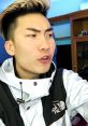 RiceGum sharing an expressive moment while wearing a stylish jacket, emphasizing his engaging online persona.