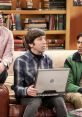 Howard Wolowitz using a laptop with friends in a cozy living room, surrounded by books, showcasing their witty interactions.