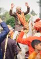 Baraat The of dhols beating in rhythmic unity fills the air, announcing the arrival of the baraat. The deep, resonant "ddm"