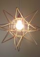 Star-shaped gold chandelier with a bright bulb, adding modern flair and artistic illumination to any room.