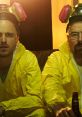 Walter White and Jesse Pinkman in iconic yellow hazmat suits, captured in a tense moment from the series Breaking Bad.