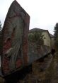 Abandoned pathway featuring a weathered relief sculpture, creating a haunting atmosphere for exploration enthusiasts.