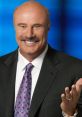 Dr. Phil smiling and gesturing, dressed in a suit with a colorful tie, showcasing his approachable personality and warmth.