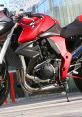 Red and black sports bike with sleek design and modern features, showcasing its powerful engine and performance aspects.