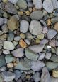 Colorful assortment of smooth pebbles and stones, showcasing natural textures and earthy tones in a rocky landscape.