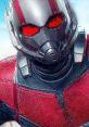 Close-up of Ant-Man in a sleek suit, showcasing vibrant red and silver details, ready for action against a blue background.