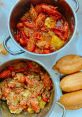 Cua dish featuring spicy crawfish stew and bread rolls, showcasing vibrant colors and rich flavors for seafood lovers.