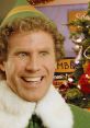 Buddy the Elf grinning joyfully in a festive setting, surrounded by holiday decorations and a Christmas tree.