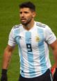 Aguero in Argentina's national team jersey, showcasing his intensity during a match, highlighting his football skills.