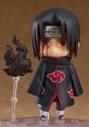 Sasuke collectible figure featuring red eyes and iconic Akatsuki cloak, complete with a dark swirling effect.