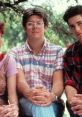 Three characters from "Sixteen Candles" in a casual setting, showcasing iconic 80s fashion and friendship dynamics.