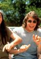 Friends laughing and enjoying carefree summer vibes in a nostalgic scene from the classic movie "Dazed and Confused.